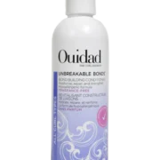 Close-up of a bottle of Ouidad Featherlight Volumizing Foam curly hair product against a transparent background.